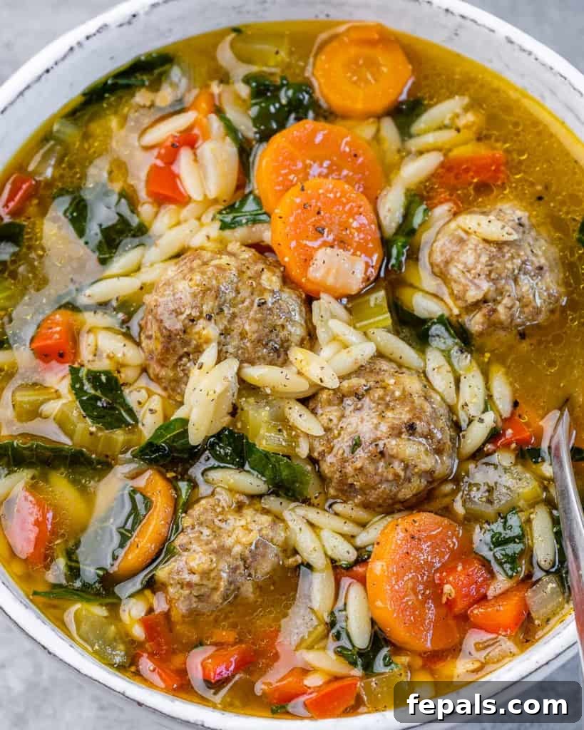 Nonna's Italian Wedding Soup 9 top close up view of meatball soup with veggies in a white bowl