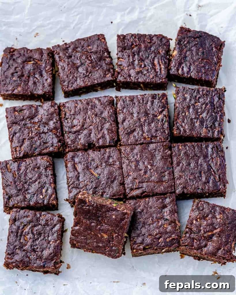 A close-up shot of freshly baked, sliced healthy zucchini brownies, ready to be served.