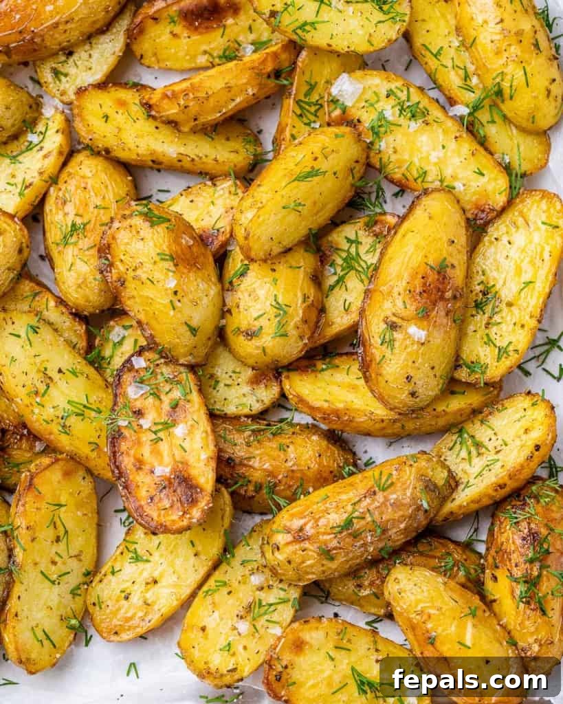 Lemon Herb Greek Baked Fingerlings 8 close up crispy baked potato wedges on a pan