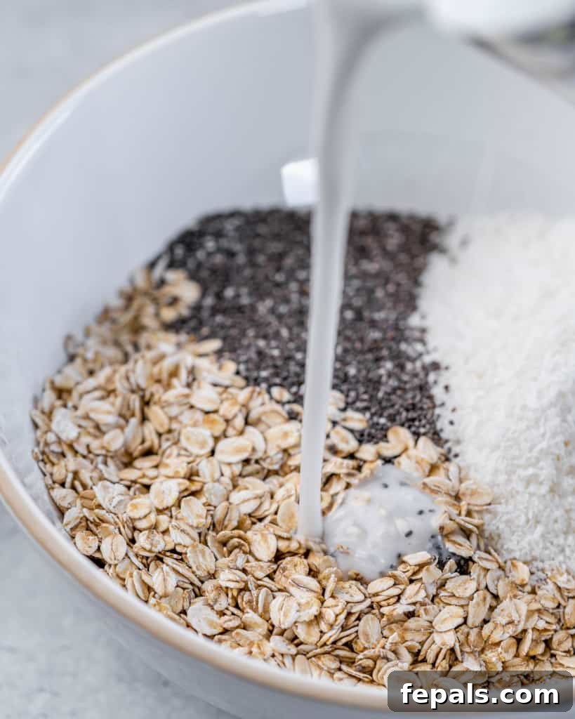 Coconut Cream Pie Dream Oats 5 Pouring milk into a bowl with oats and chia seeds.