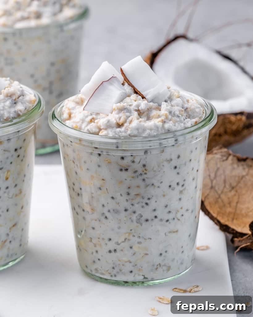 Coconut Cream Pie Dream Oats 9 Glass jars filled with overnight oats topped with chunks of coconut.