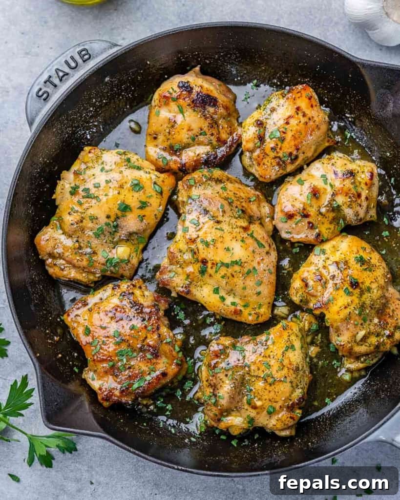 Effortless Baked Boneless Thighs 2 top view of cooked chicken thighs in a black skillet
