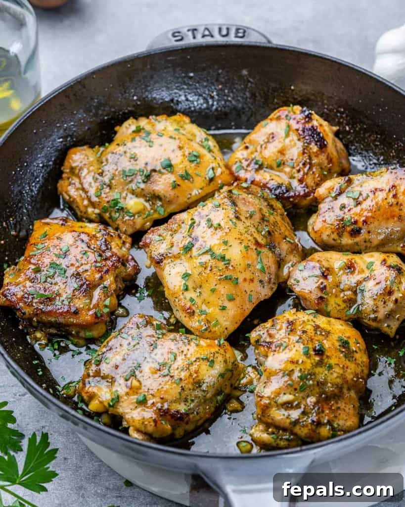 Effortless Baked Boneless Thighs 11 side shot of a black skillet with baked boneless chicken thighs