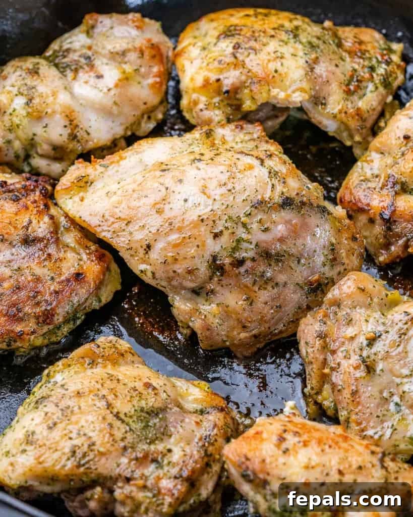 Effortless Baked Boneless Thighs 6 chicken thighs sauteed in a black pan before being placed in oven