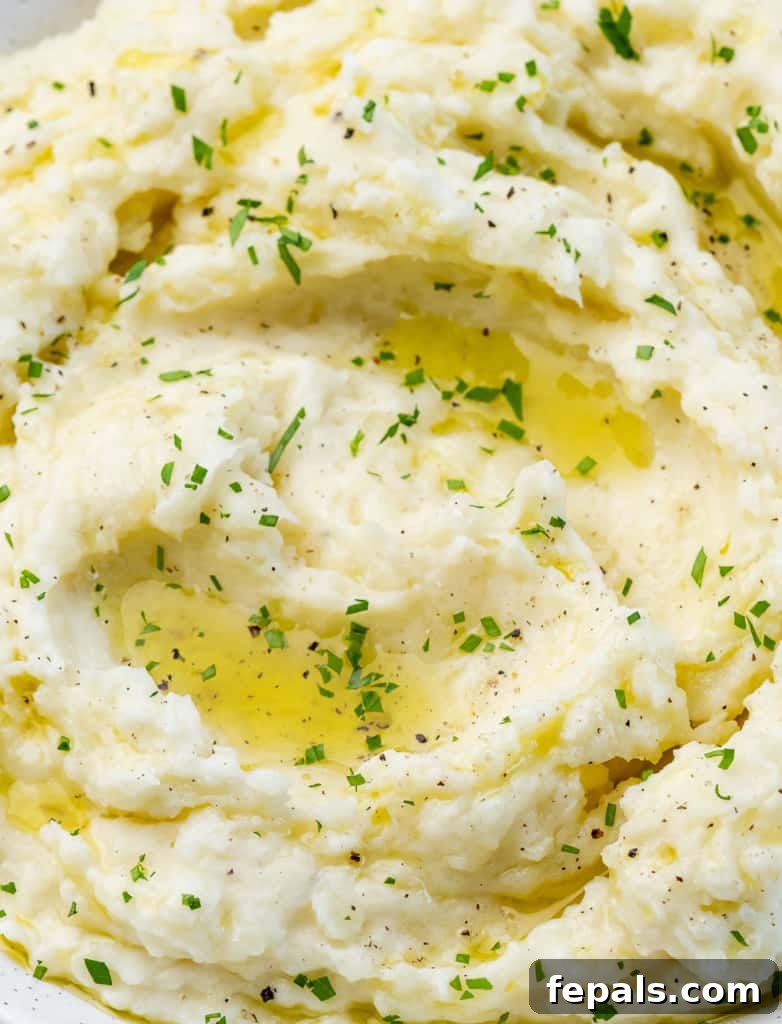 Vegan mashed potatoes drizzled with olive oil and garnished with fresh parsley.