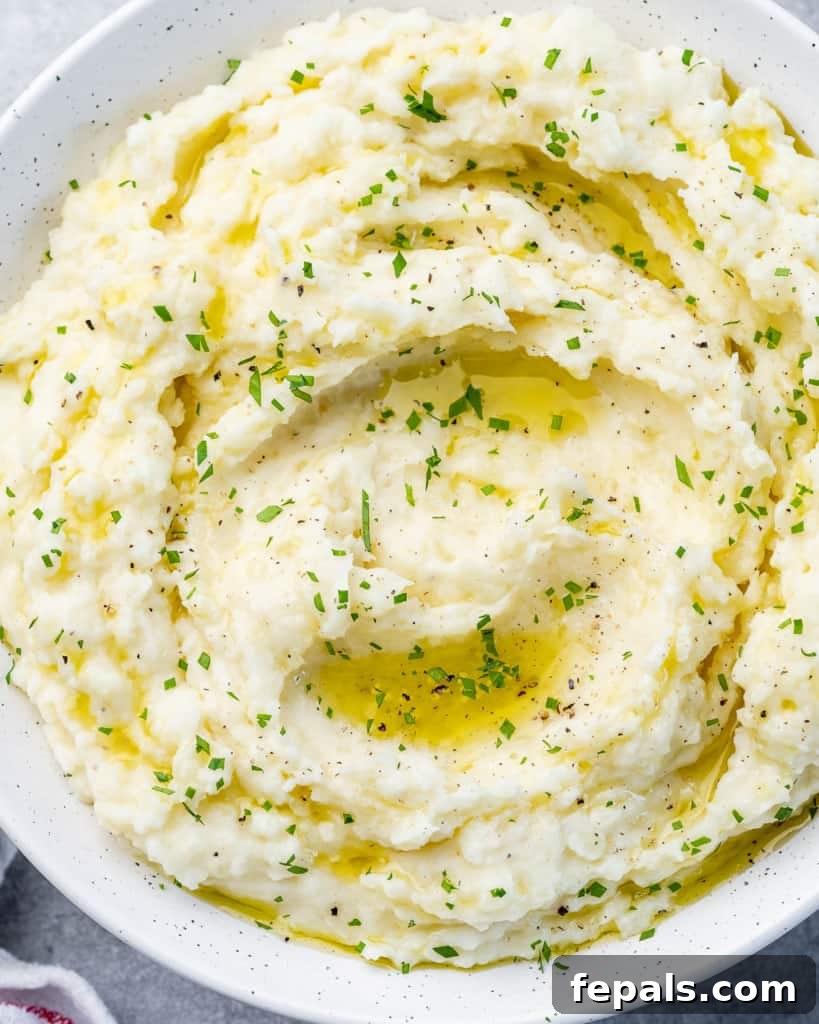 Potatoes mashed in a white serving bowl, ready to be dished out.
