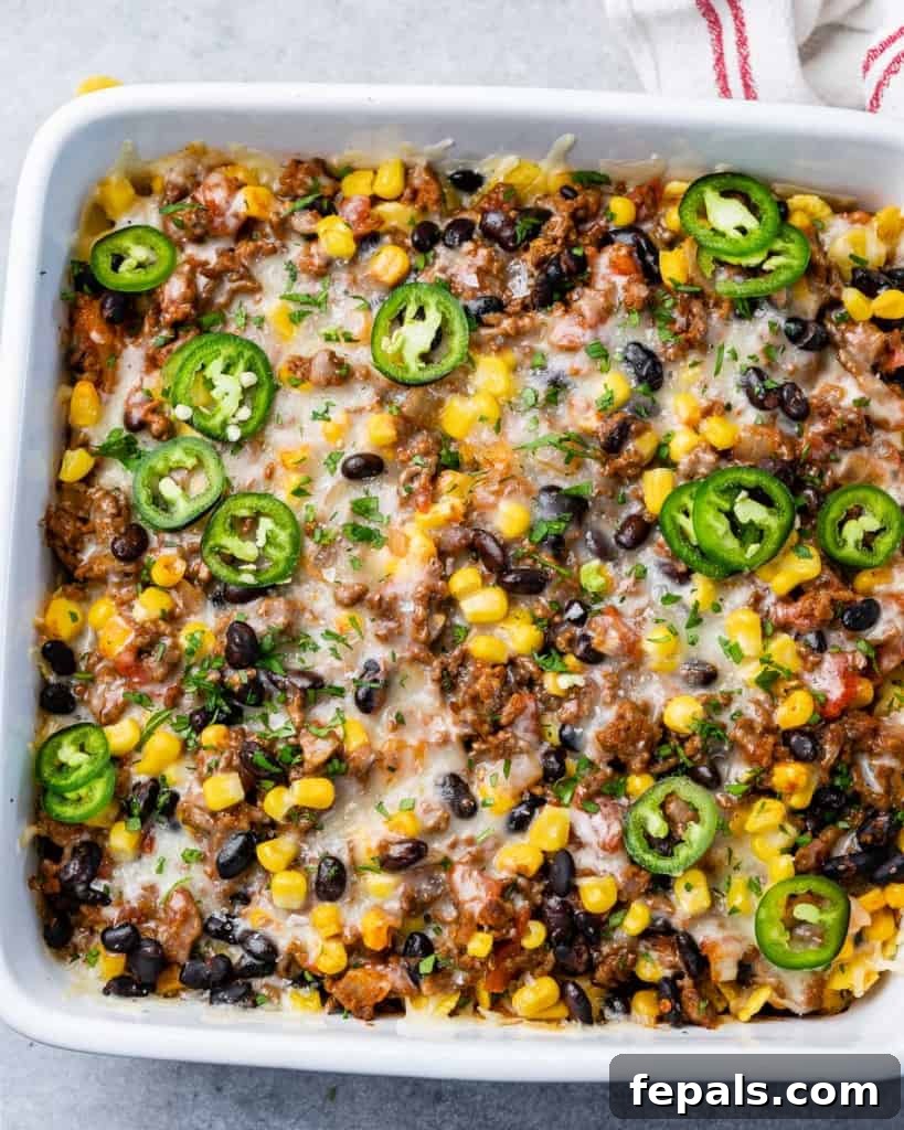 Top view of a complete taco casserole dish with melted cheese, ready for serving.
