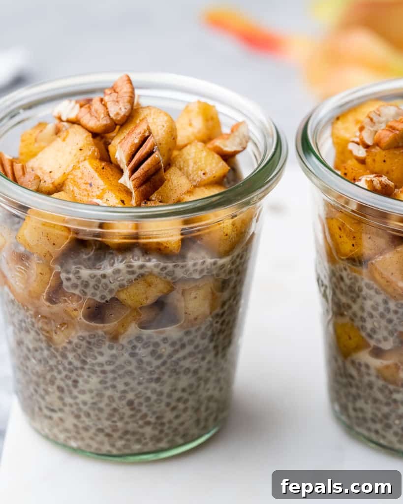 Spiced Apple Pie Chia Pudding 9 Side shot of two jars of chia seed pudding topped with cinnamon apples, looking inviting and delicious