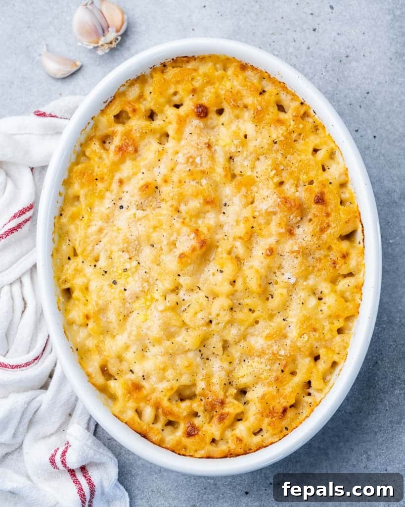 Top view of baked mac and cheese in a white oval dish, perfectly golden and bubbly.