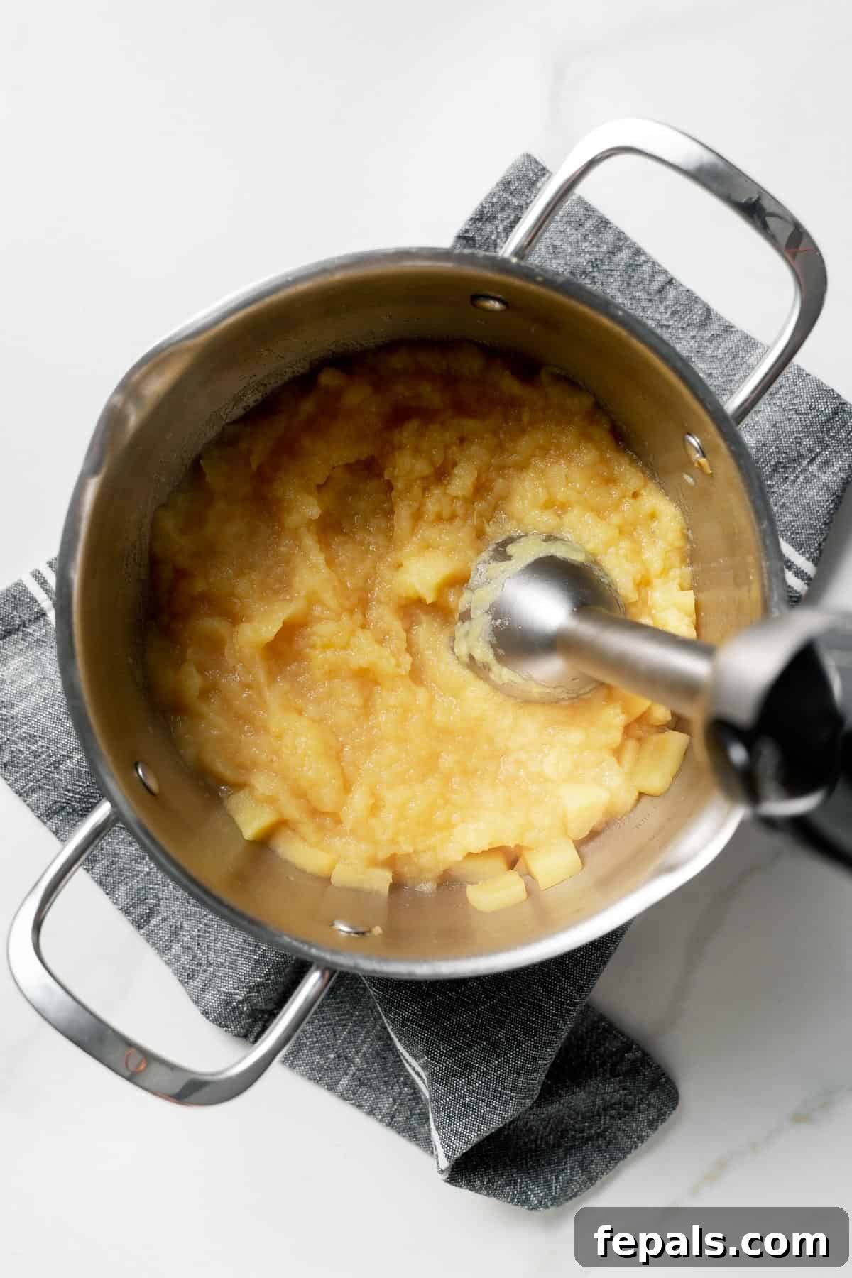 blending the apples with immersion blender