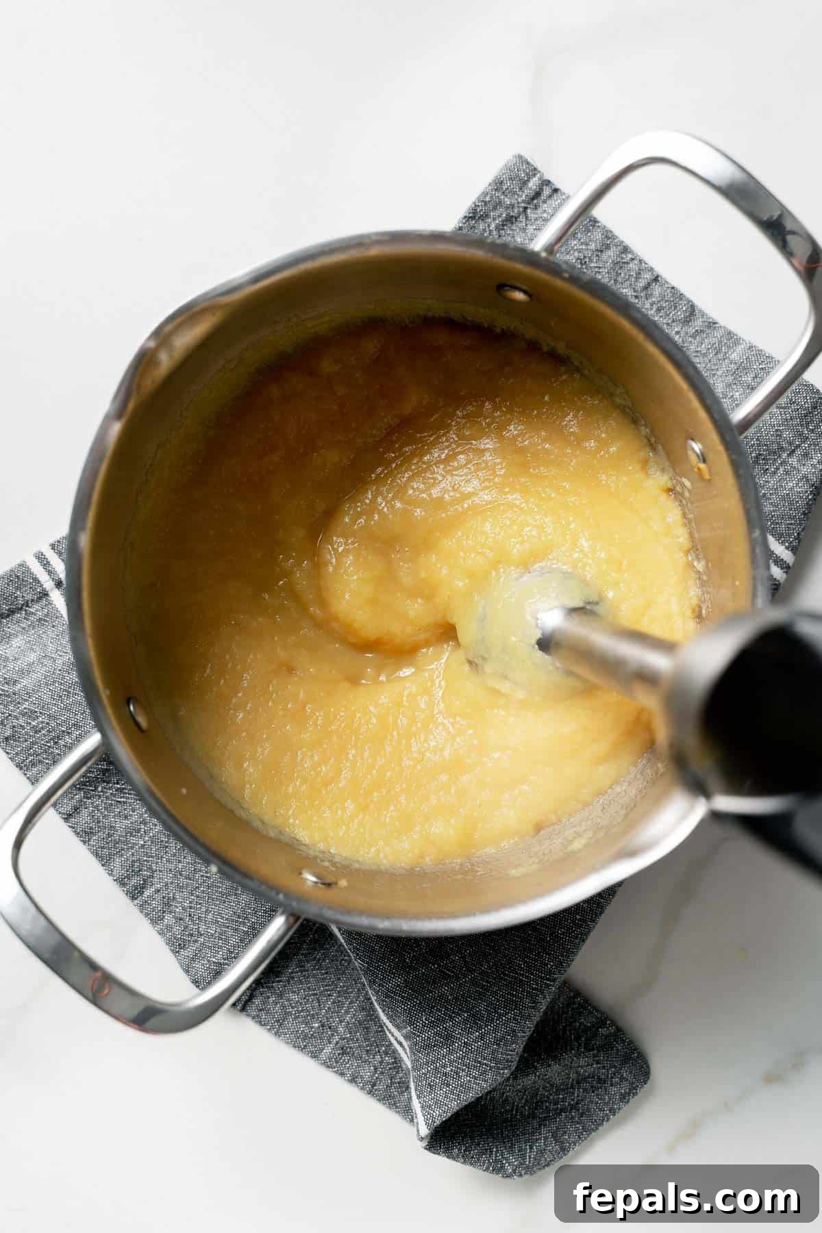 blending the apples with immersion blender