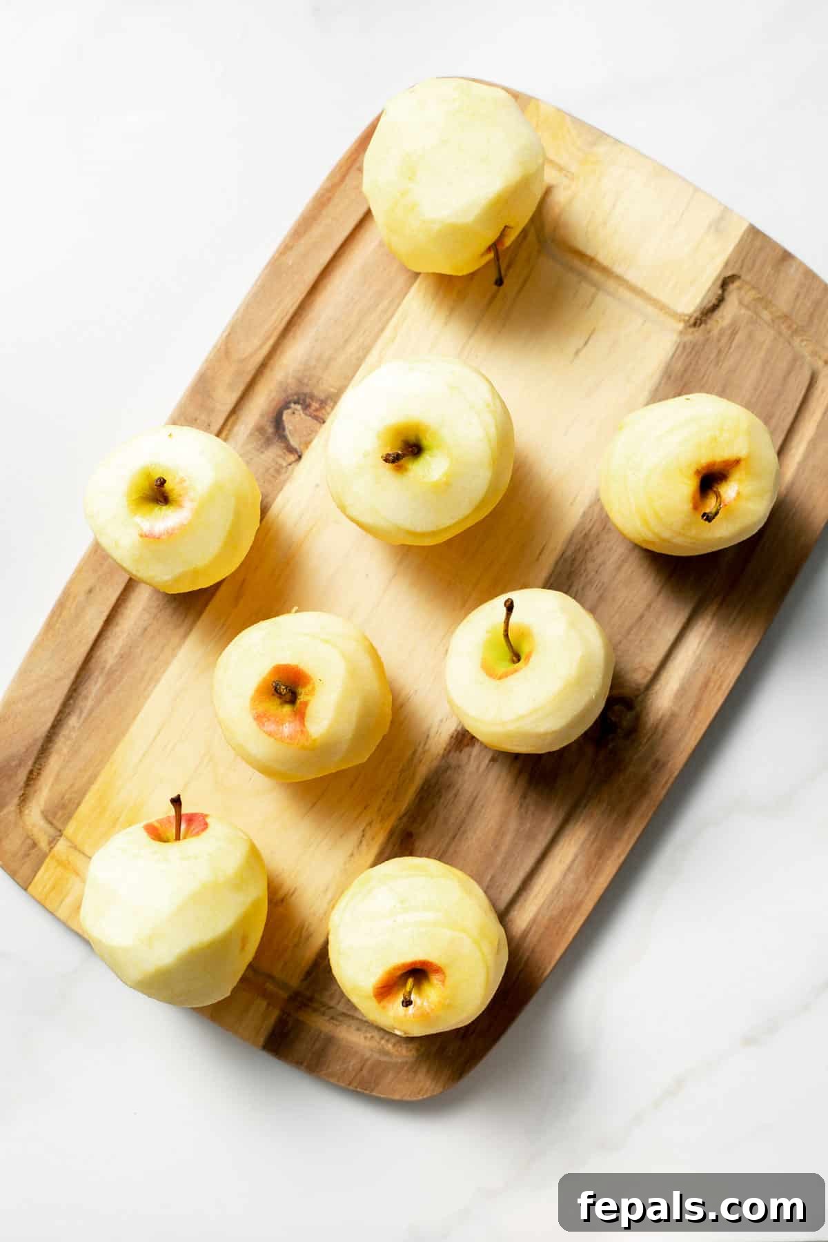 peeled apples on cutting board