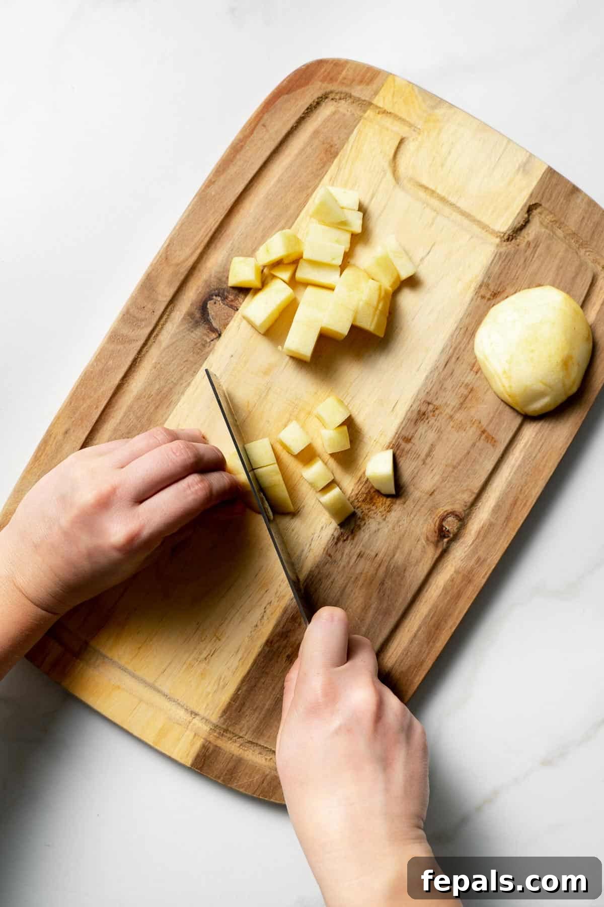 slicing the apples into smaller chunks with a knife