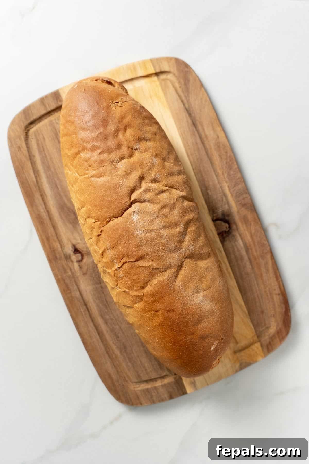 How To Make Croutons one loaf of bread on cutting board
