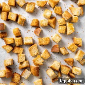 top view of croutons on baking sheet with parchment paper