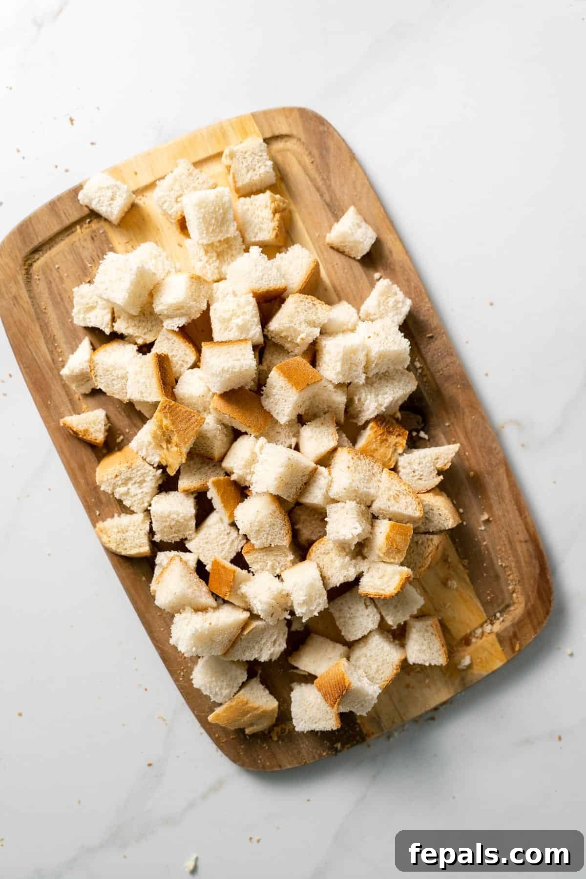How To Make Croutons bread cubes on top of cutting board
