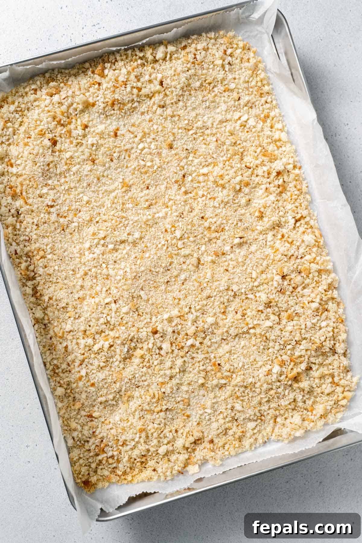 How To Make Breadcrumbs bread crumbs on baking sheet with parchment paper
