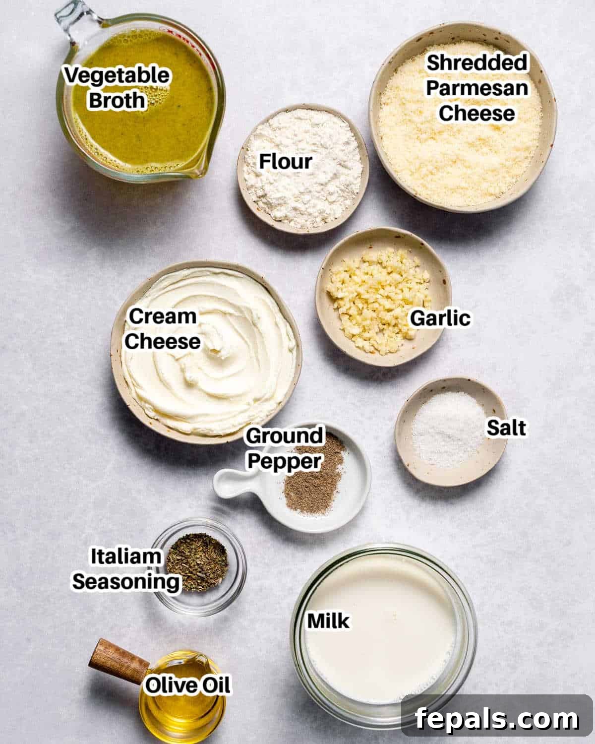 A vibrant flat lay of all the fresh ingredients required to make the healthy alfredo sauce recipe.