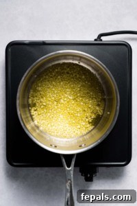 Garlic simmering in oil in a saucepan for the Alfredo sauce.