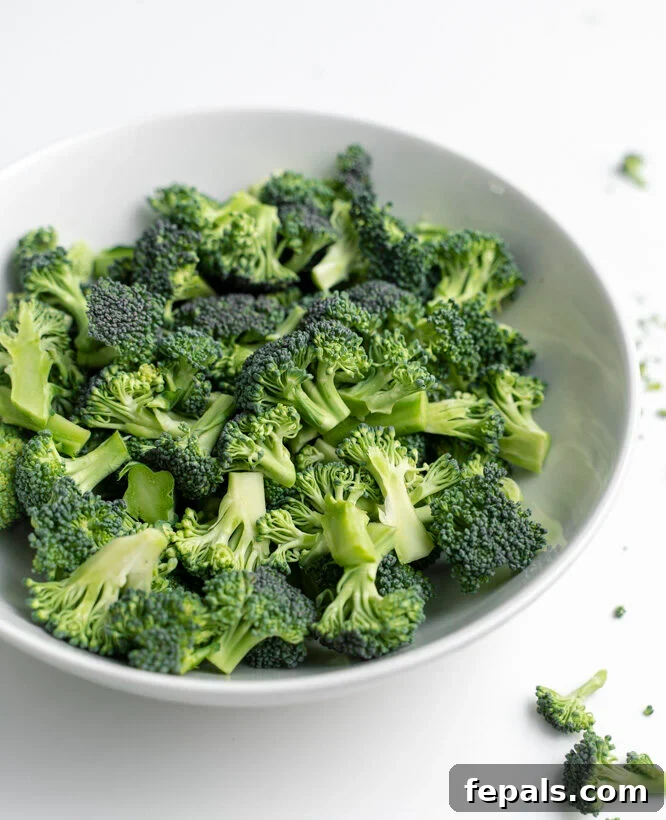 How to Perfectly Cut Broccoli 2 Cut up broccoli in a white bowl.