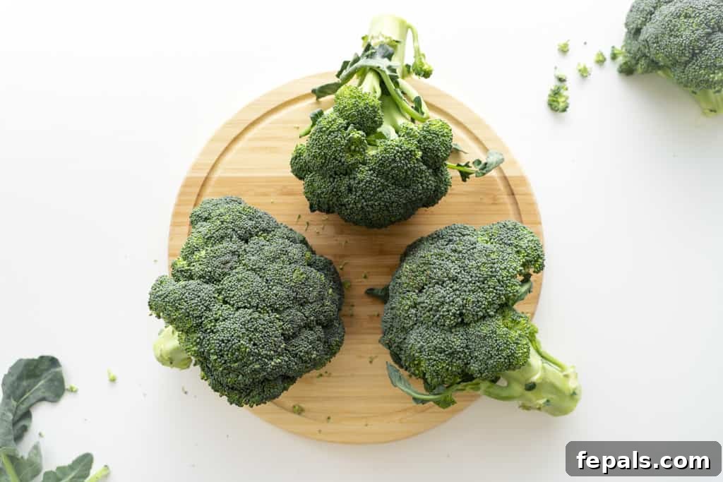 How to Perfectly Cut Broccoli 3 Three heads of broccoli on a cutting board.
