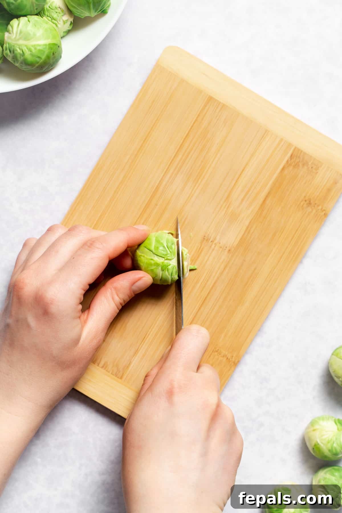 How To Cut Brussels Sprouts Trimming the woody stem end off a Brussels sprout with a knife