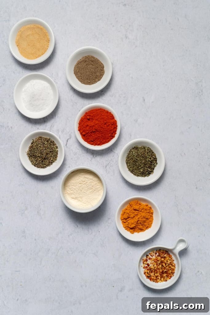 Mastering Cajun Seasoning From Scratch 2 garlic powder, oregano, thyme, cayenne pepper, salt, black pepper, paprika in bowls