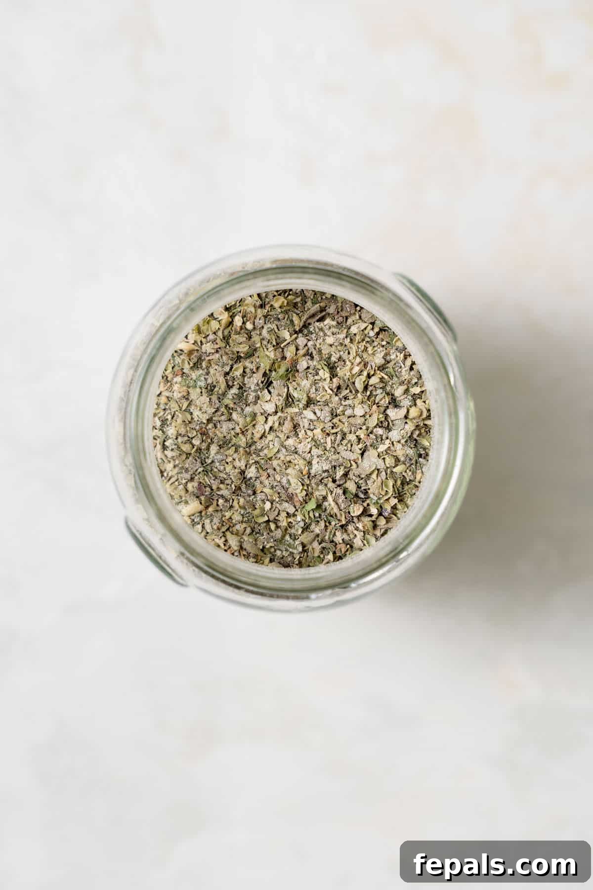 Top view of Greek seasoning freshly transferred into a glass jar