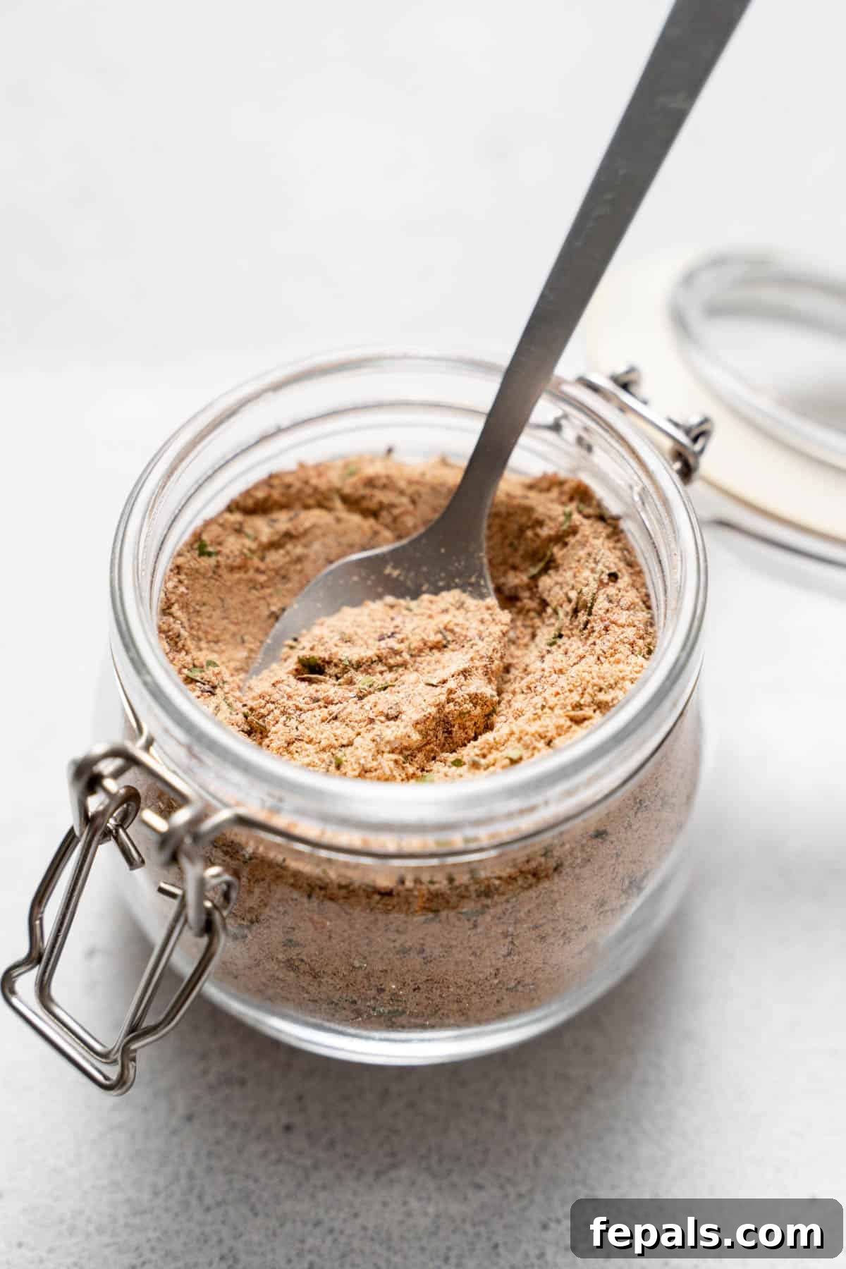 Jerk Spice Blend A single jar, perfectly filled with aromatic jerk seasoning blend, showcasing its rich texture and color.