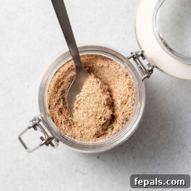 Crafting Authentic Jerk Seasoning at Home 2 top view of jerk seasoning in a jar with spoon in it