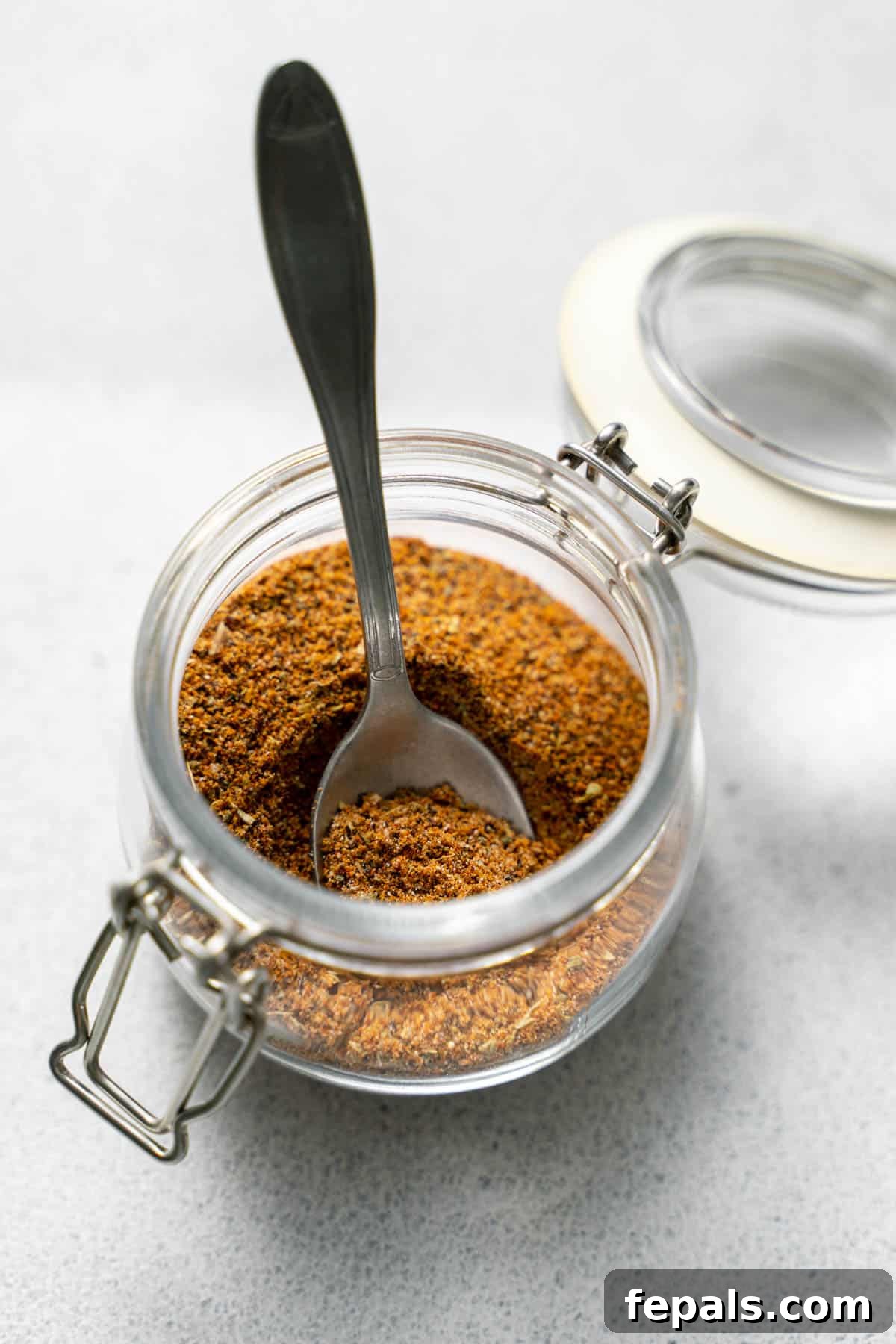 Mexican spice blend in jar with spoon 