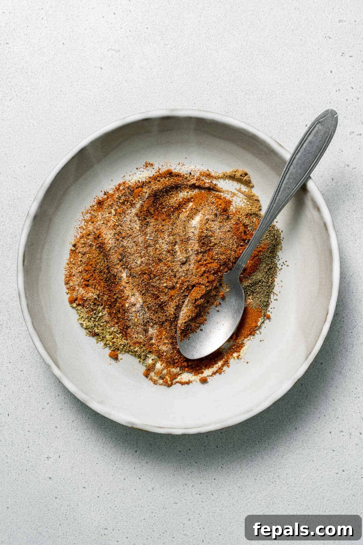 mixed spices in bowl with spoon