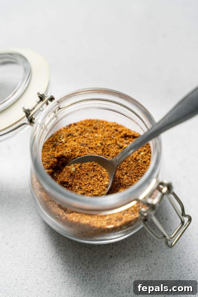 Mexican seasoning in jar with spoon