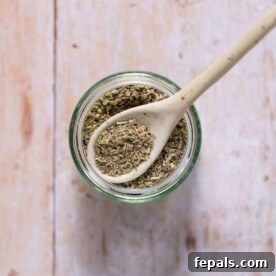 poultry seasoning in a jar with spoon over it