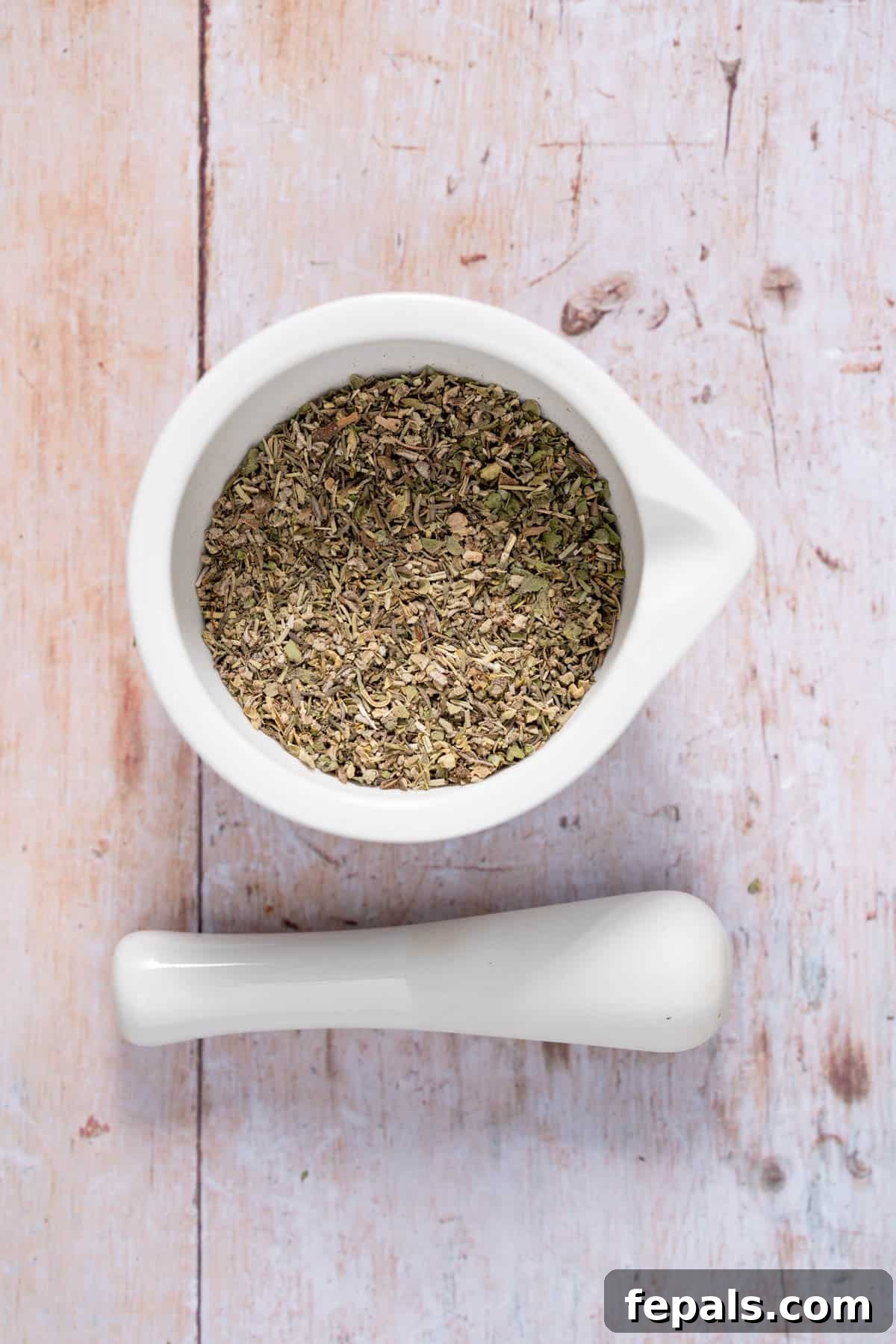 How To Make Poultry Seasoning container filled with dried seasoning mix