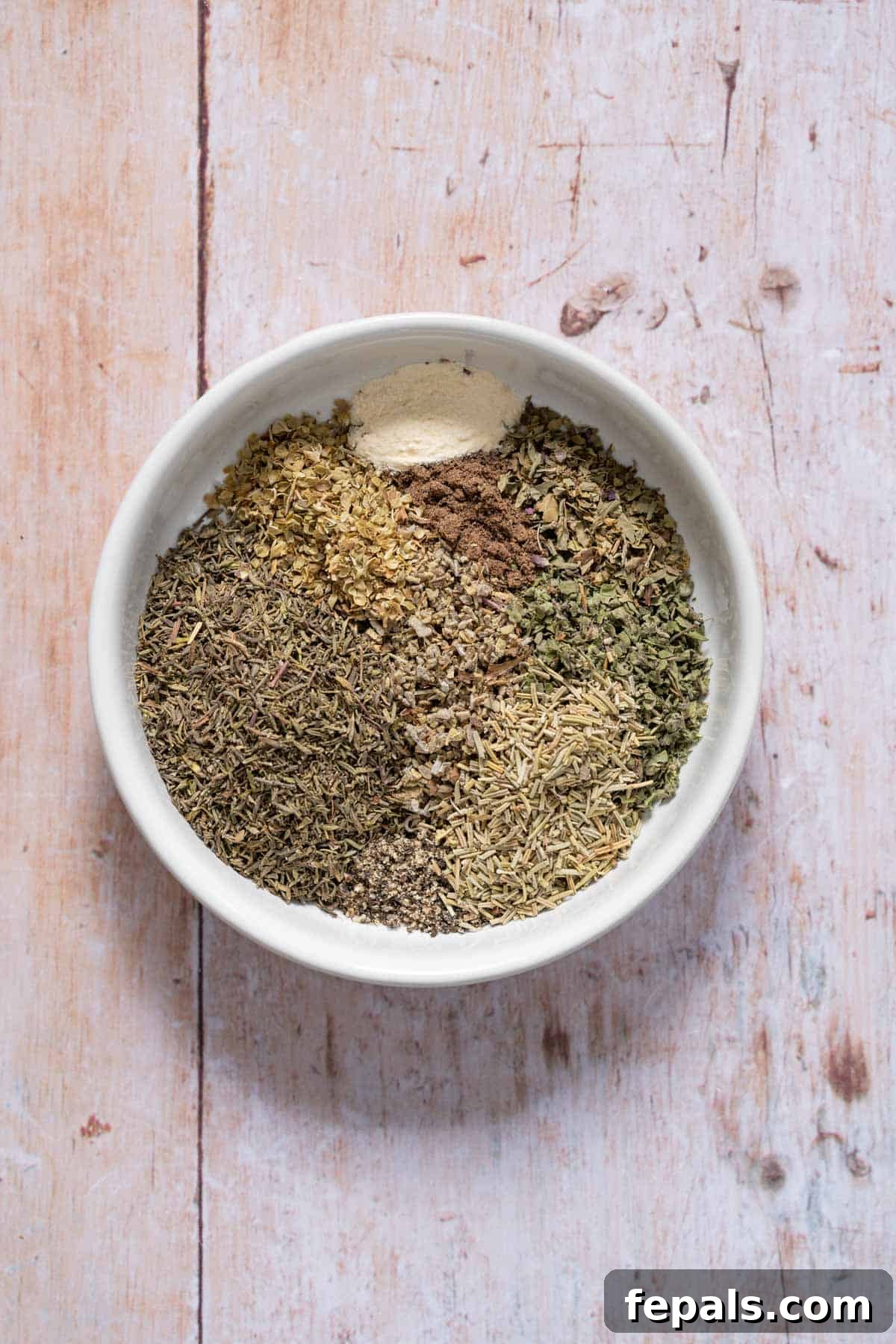 Homemade Poultry Seasoning dried herbs placed in a bowl