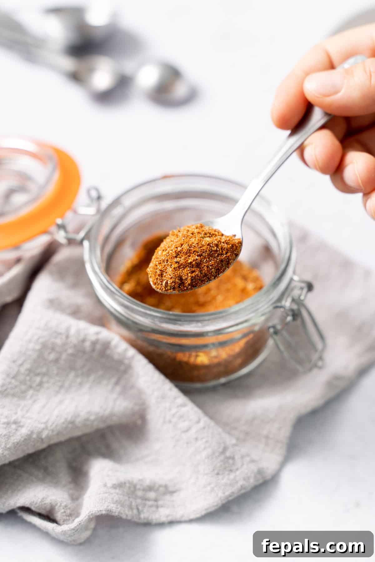 DIY Easy Taco Seasoning one jar of taco seasoning with spoon