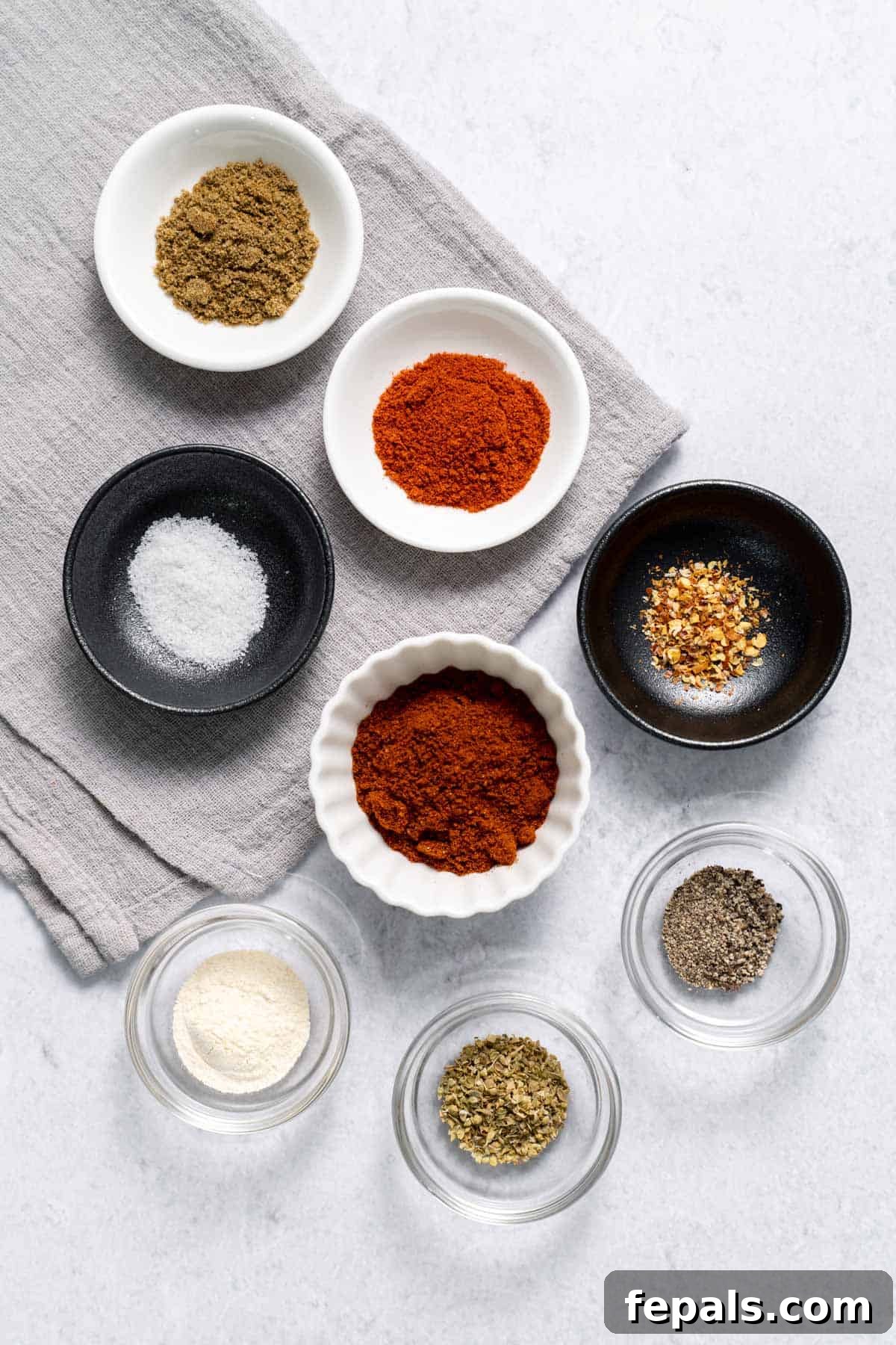 Mild Taco Seasoning paprika, cumin, chili powder, salt, pepper, chili flakes, oregano in bowls