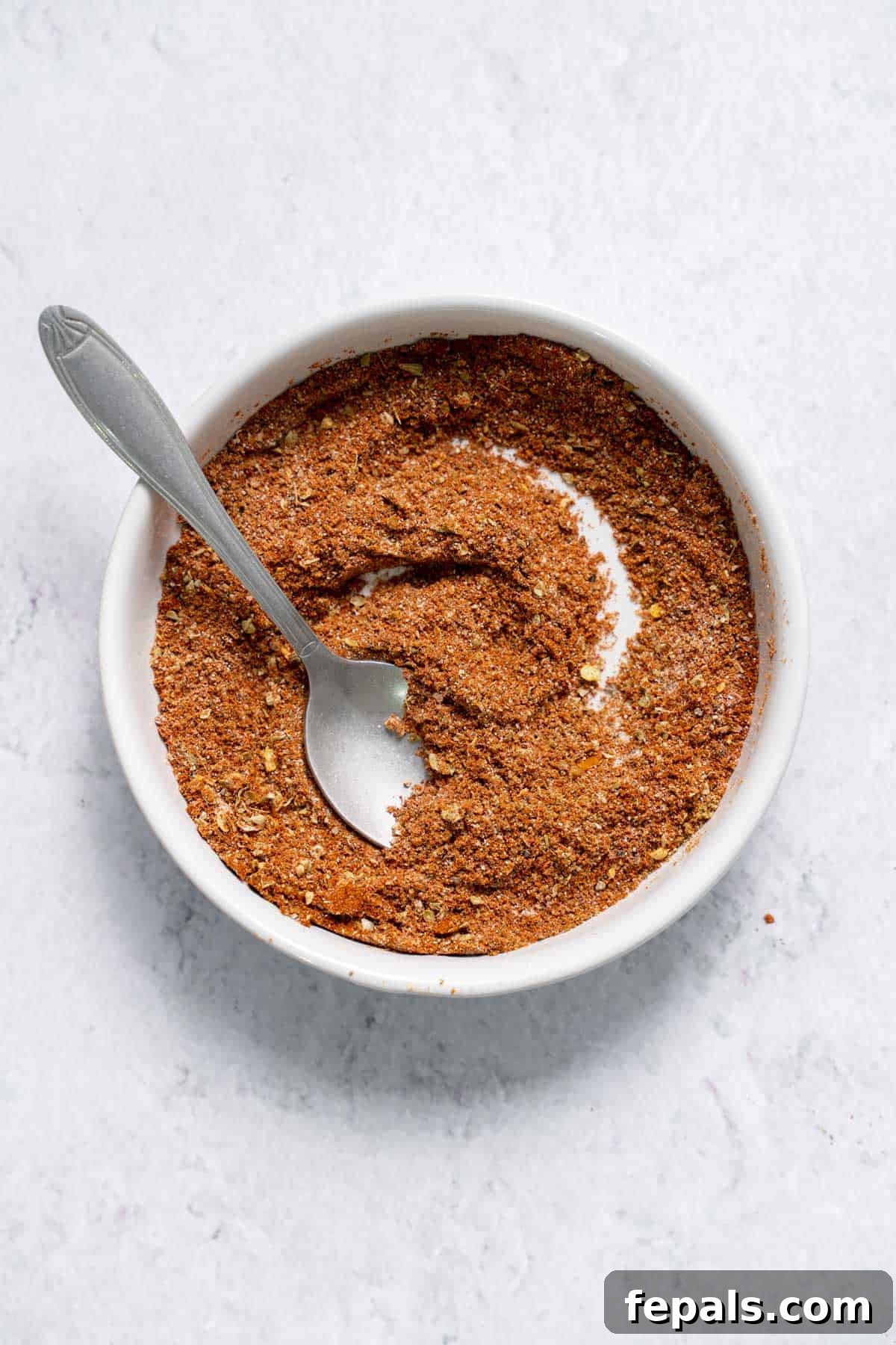 DIY Taco Seasoning mixing ground spices in bowl for taco seasoning