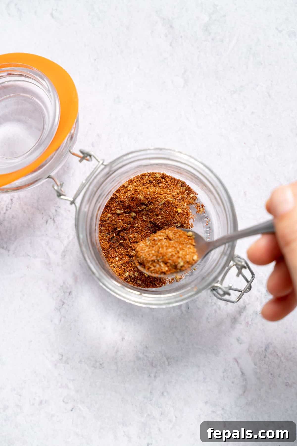 DIY Taco Mix scooping homemade taco seasoning with a spoon