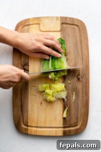 chopping romaine lettuce on cutting board