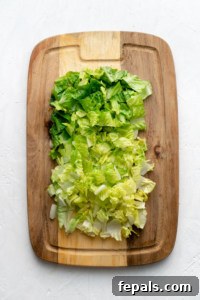 cutting board with chopped romaine lettuce