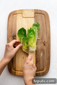 slicing romaine lettuce with knife and cutting board