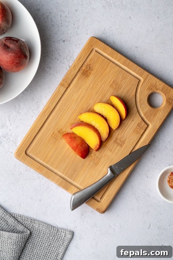 A collection of freshly cut peach slices elegantly arranged on a cutting board, showcasing the successful outcome of the slicing process.