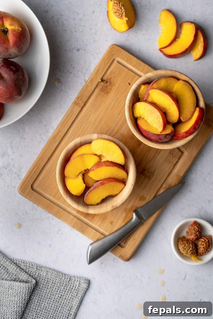 Two bowls brimming with an abundance of perfectly sliced peaches, presented beautifully and ready to be enjoyed as a refreshing snack or dessert.