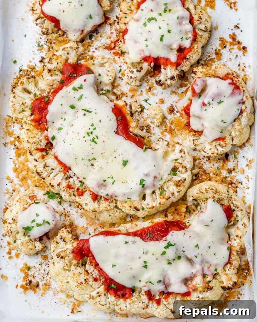 top view cauliflower steaks topped with marinara and melted cheese