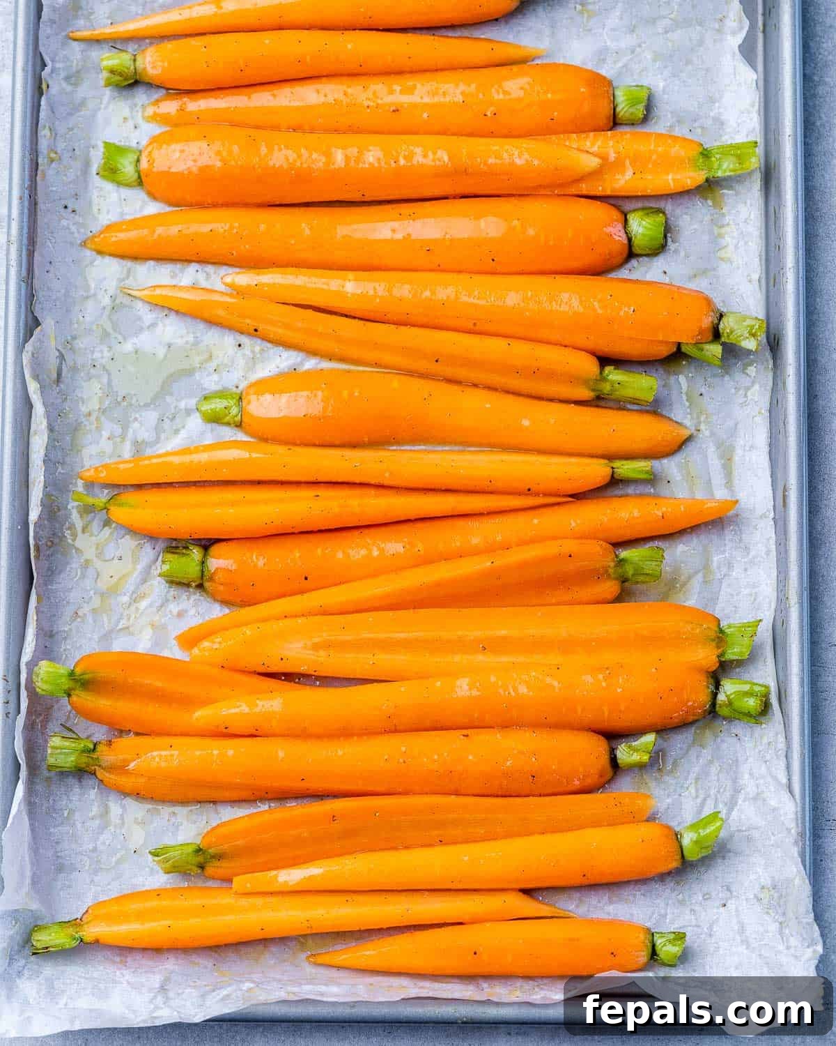 Honey-Kissed Balsamic Roasted Carrots 5 Cut carrots on a parchment lined sheet pan.