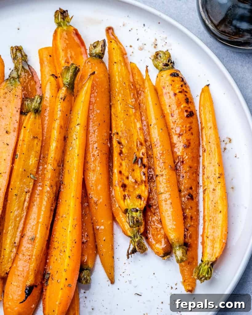 Honey-Kissed Balsamic Roasted Carrots 7 Long carrots on a plate.