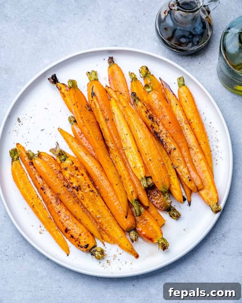 Honey-Kissed Balsamic Roasted Carrots 9 Glazed carrots on a plate.