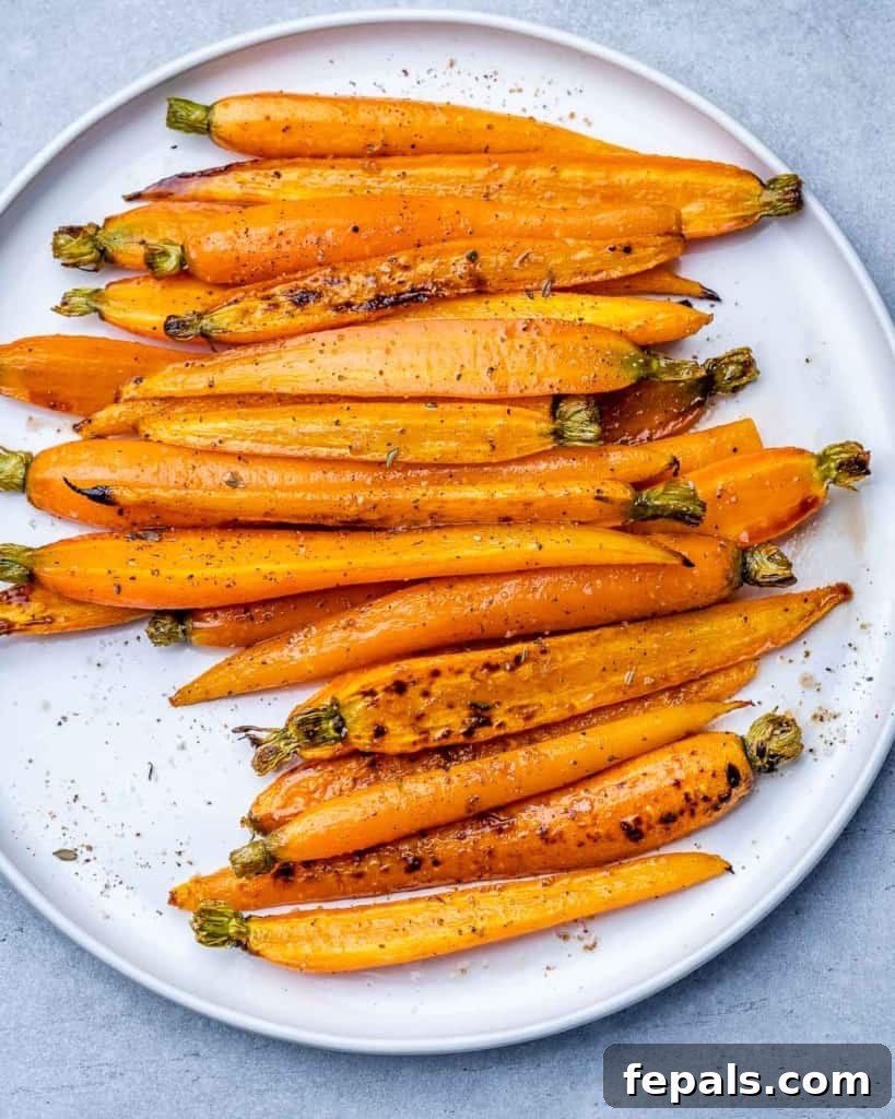 Honey-Kissed Balsamic Roasted Carrots 10 Cooked carrots on a plate.